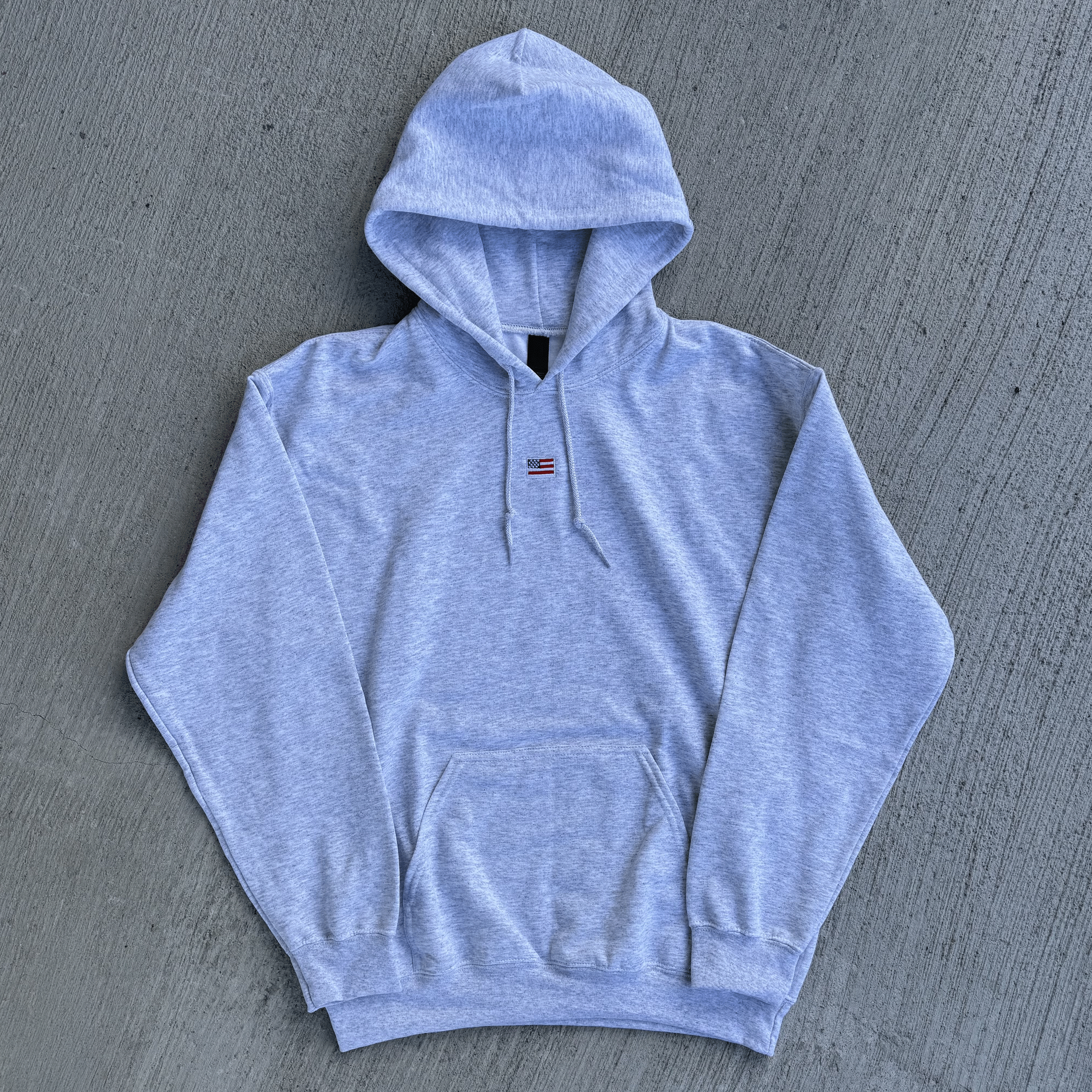 Gray hoodie on a gray textured surface