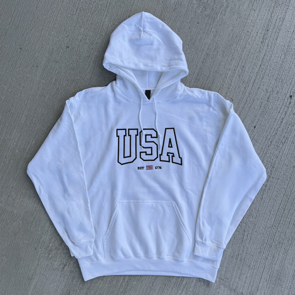 White hoodie with 'USA' text on a gray surface