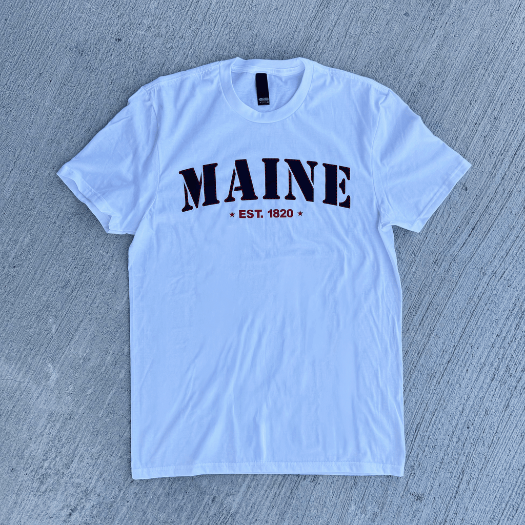 White t-shirt with 'MAINE EST. 1820' text on a gray textured background