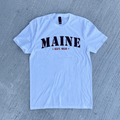 White t-shirt with 'MAINE EST. 1820' text on a gray textured background