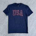 Navy blue t-shirt with 'USA' text on a gray concrete surface