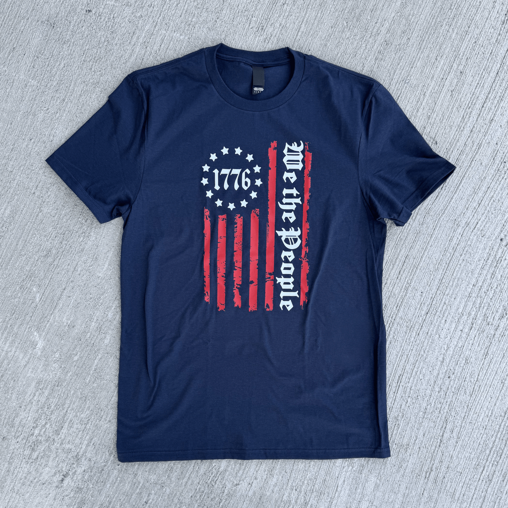 Navy blue t-shirt with a graphic design on a gray textured background