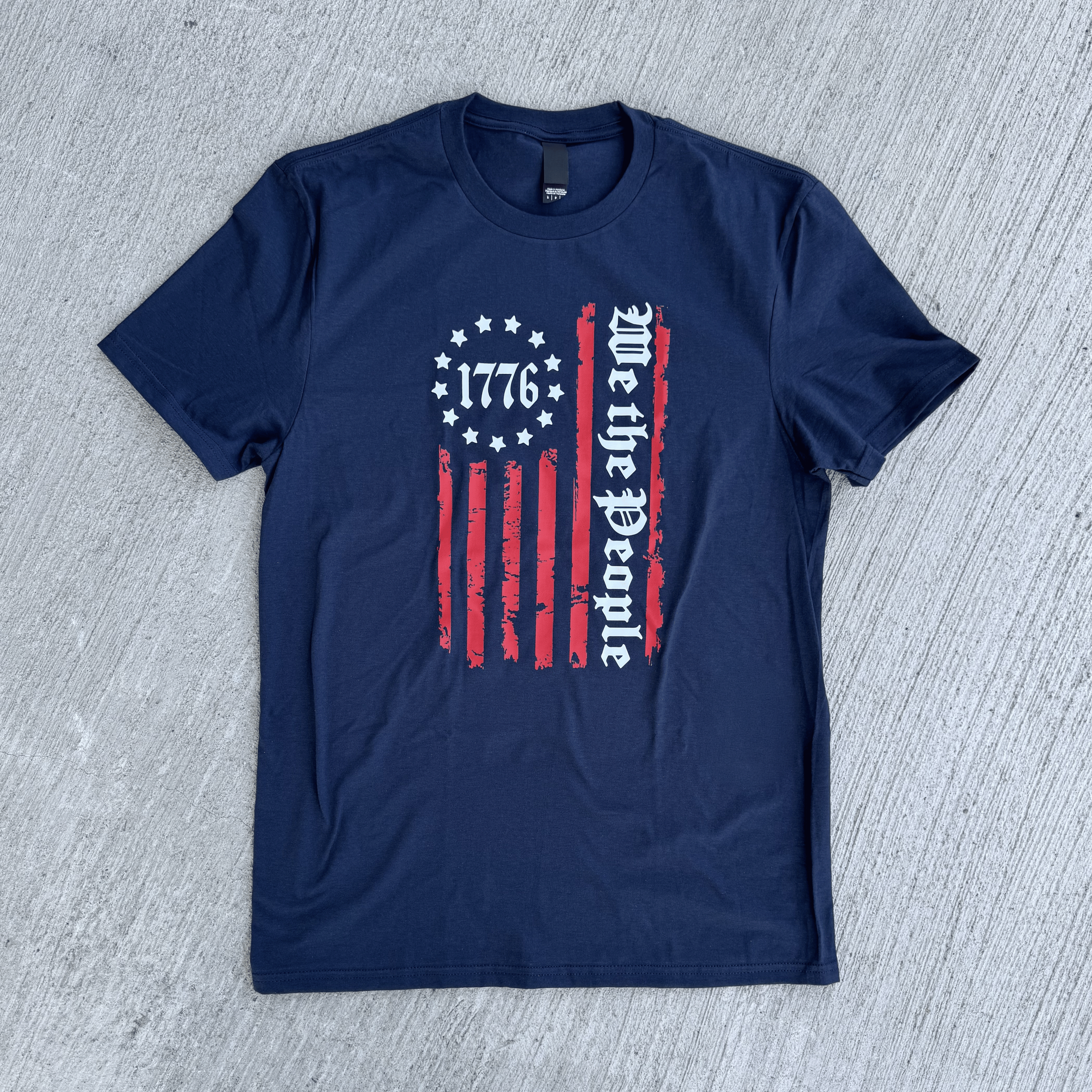 Navy blue t-shirt with a graphic design on a gray textured background