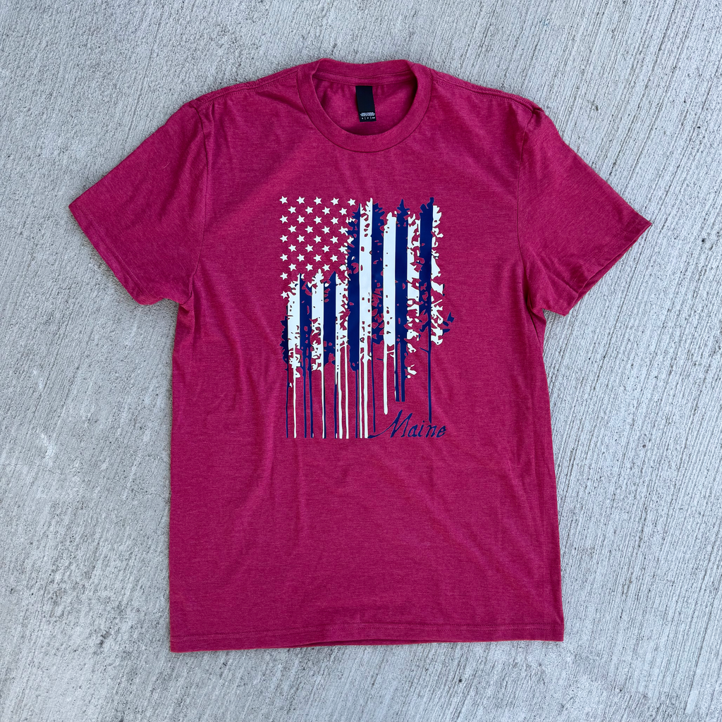 Heather red t-shirt with a graphic design on a gray surface