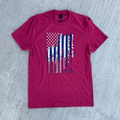 Heather red t-shirt with a graphic design on a gray surface